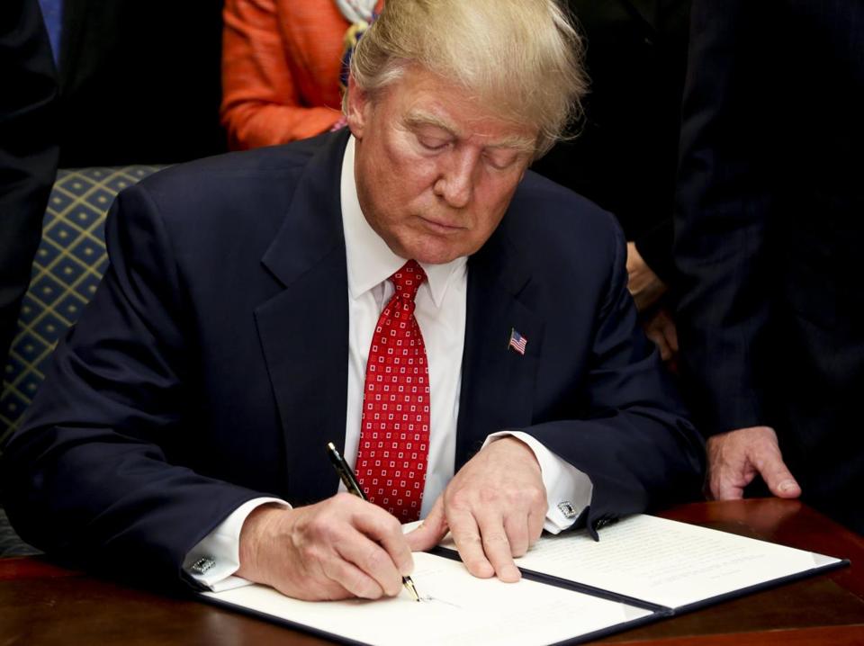 Trump signing an executive order - AUDE GUERRUCCI/EPA