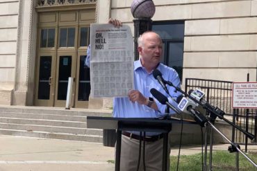 Critic protests in front of courthouse