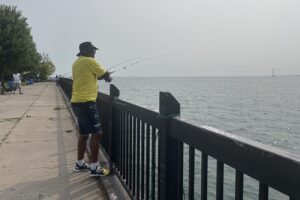 Freddie Davis casts a line into the Detroit River at Mariner Park, where he was fishing Wednesday morning. (Photo vredit: Ashley Zhou)